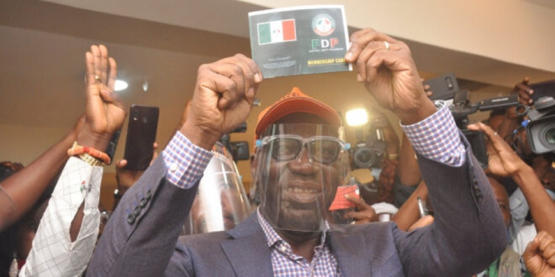 Governor Obaseki displaying his PDP membership card